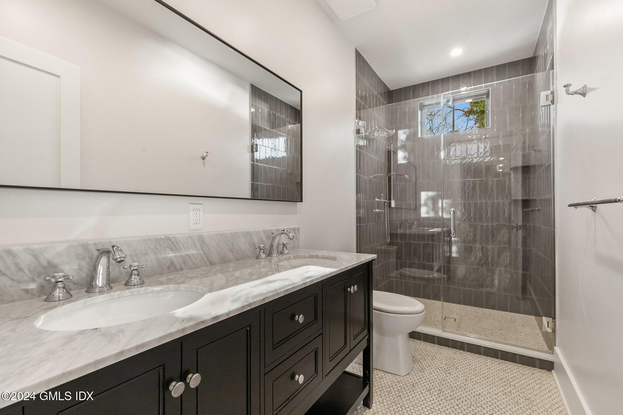 96 Weaver Street, Unit A Greenwich, CT 06831 - Photo 12 of 26 a bathroom with a double vanity sink toilet and shower