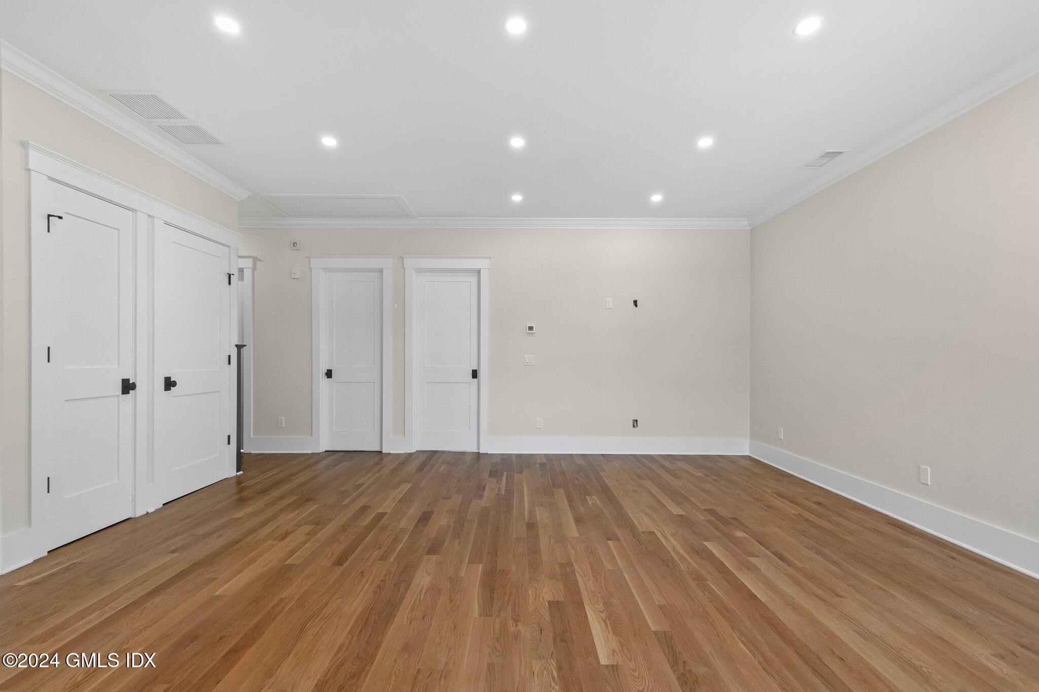 96 Weaver Street, Unit A Greenwich, CT 06831 - Photo 19 of 26 a view of room with wooden floor and white walls