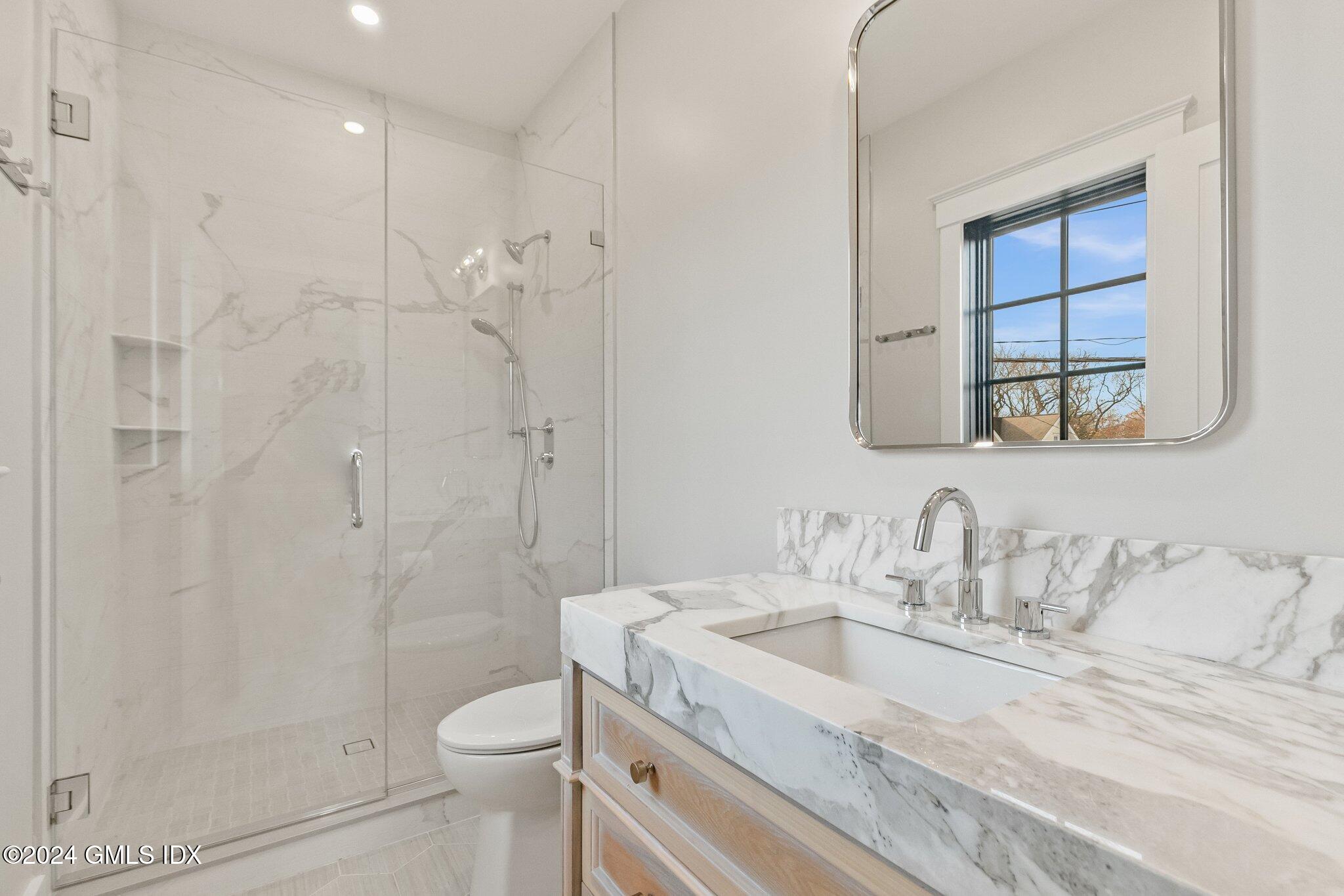 96 Weaver Street, Unit A Greenwich, CT 06831 - Photo 20 of 26 a bathroom with a granite countertop sink a toilet and shower