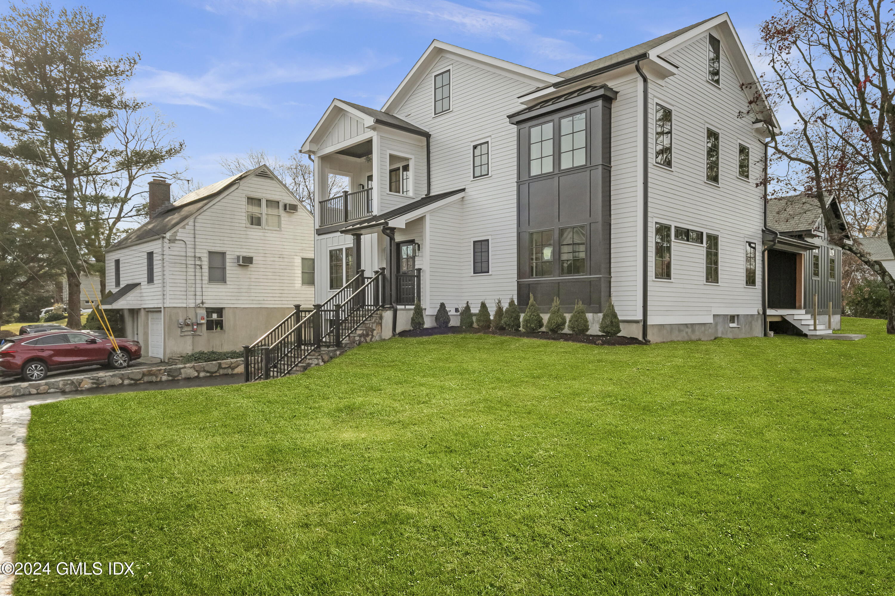 96 Weaver Street, Unit A Greenwich, CT 06831 - Photo 2 of 26 a front view of a house with a garden