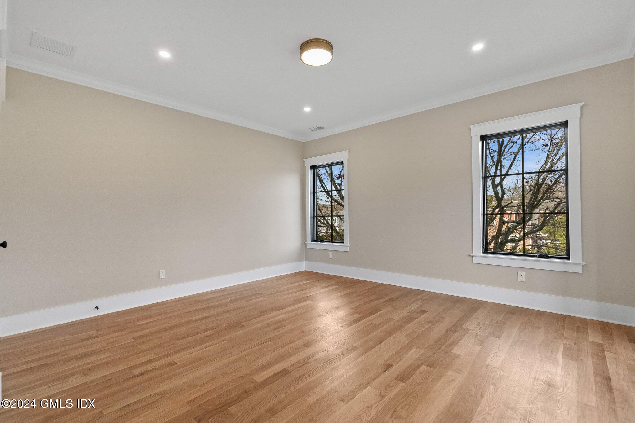 96 Weaver Street, Unit A Greenwich, CT 06831 - Photo 22 of 26 wooden floor in an empty room with a window