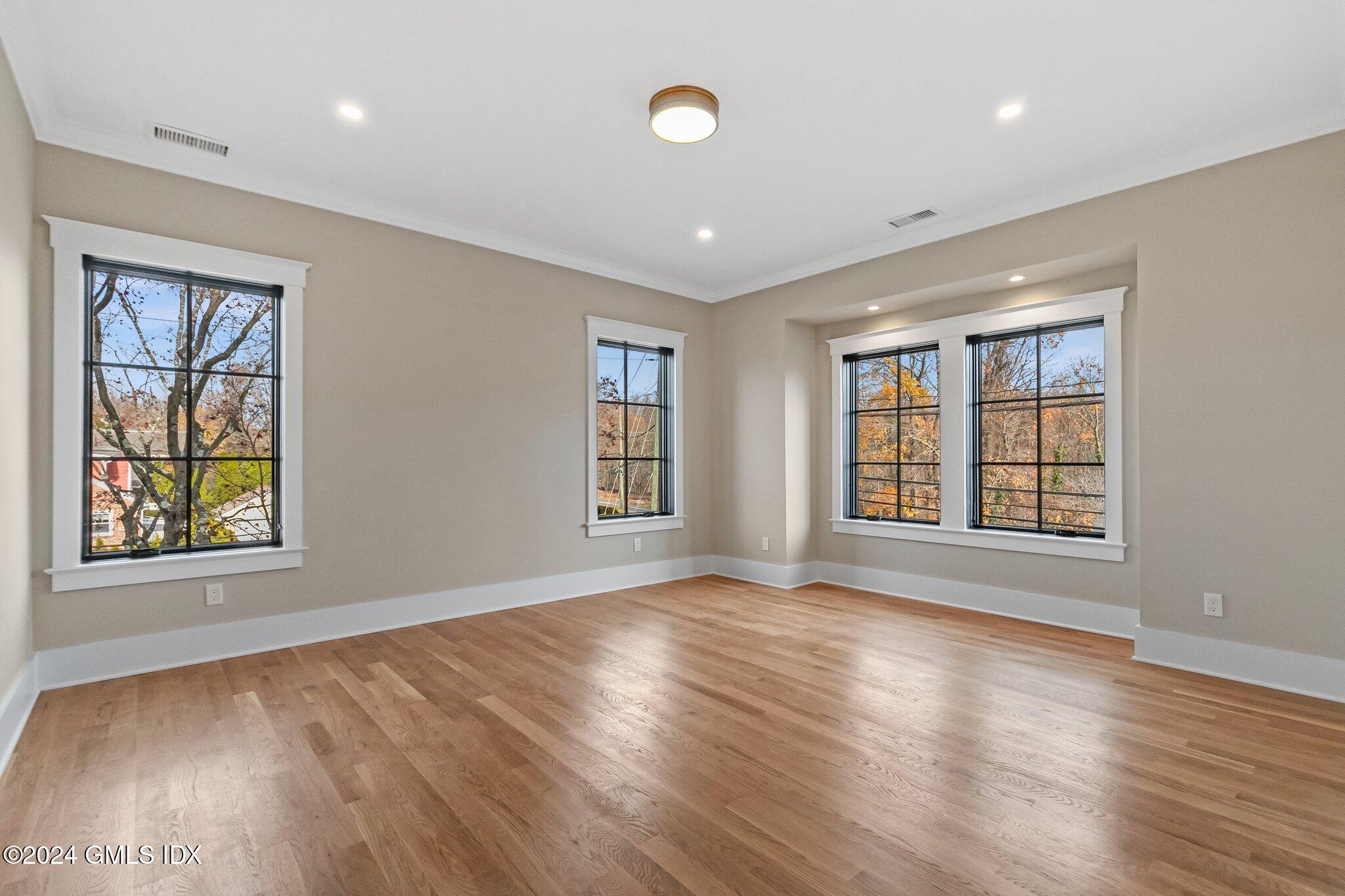 96 Weaver Street, Unit A Greenwich, CT 06831 - Photo 23 of 26 a view of an empty room with wooden floor and a window
