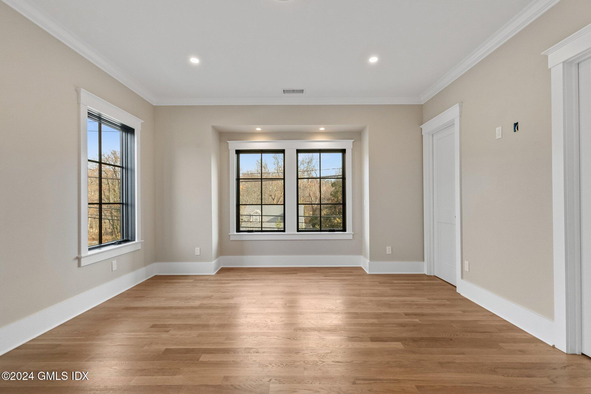 96 Weaver Street, Unit A Greenwich, CT 06831 - Photo 24 of 26 a view of an empty room with wooden floor and a window