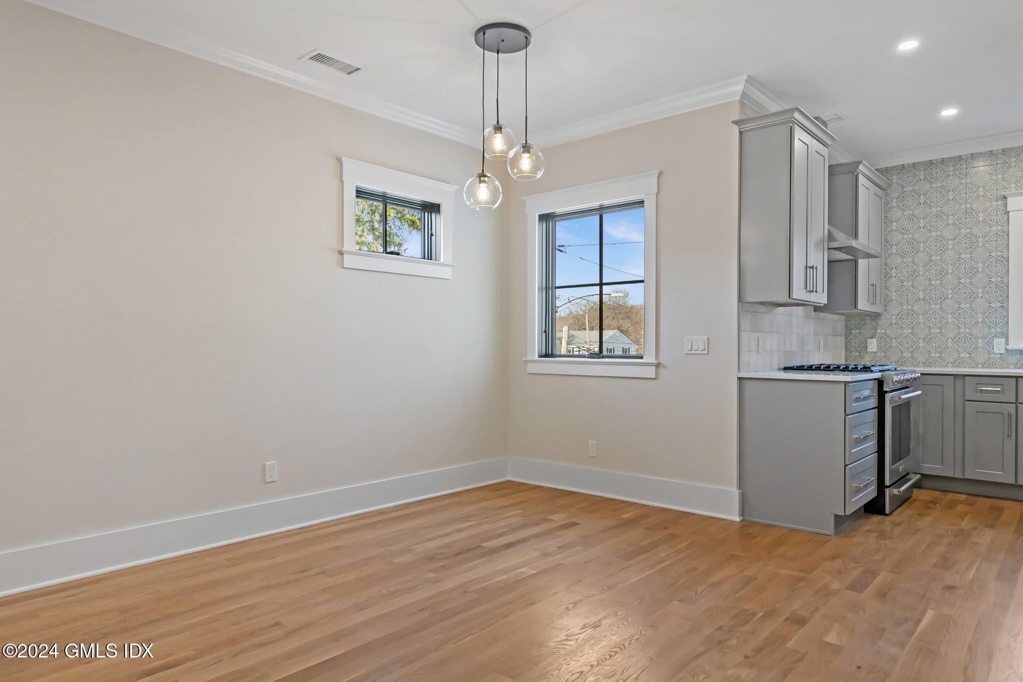96 Weaver Street, Unit A Greenwich, CT 06831 - Photo 7 of 26 a view of a kitchen with dishwasher cabinet and a window