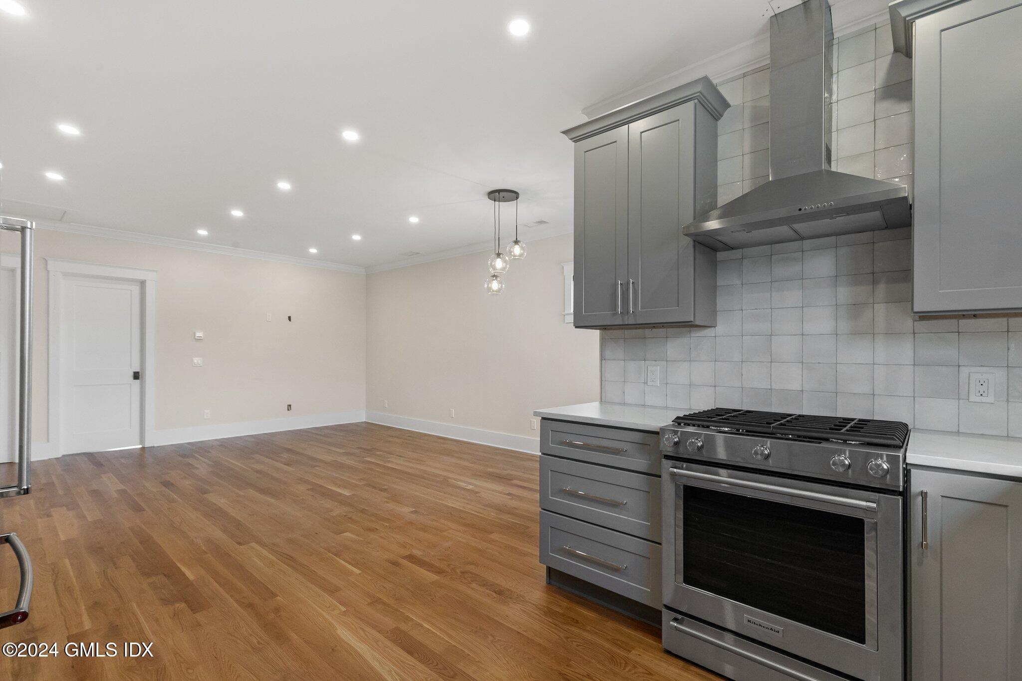96 Weaver Street, Unit A Greenwich, CT 06831 - Photo 8 of 26 a kitchen with granite countertop a stove and a sink