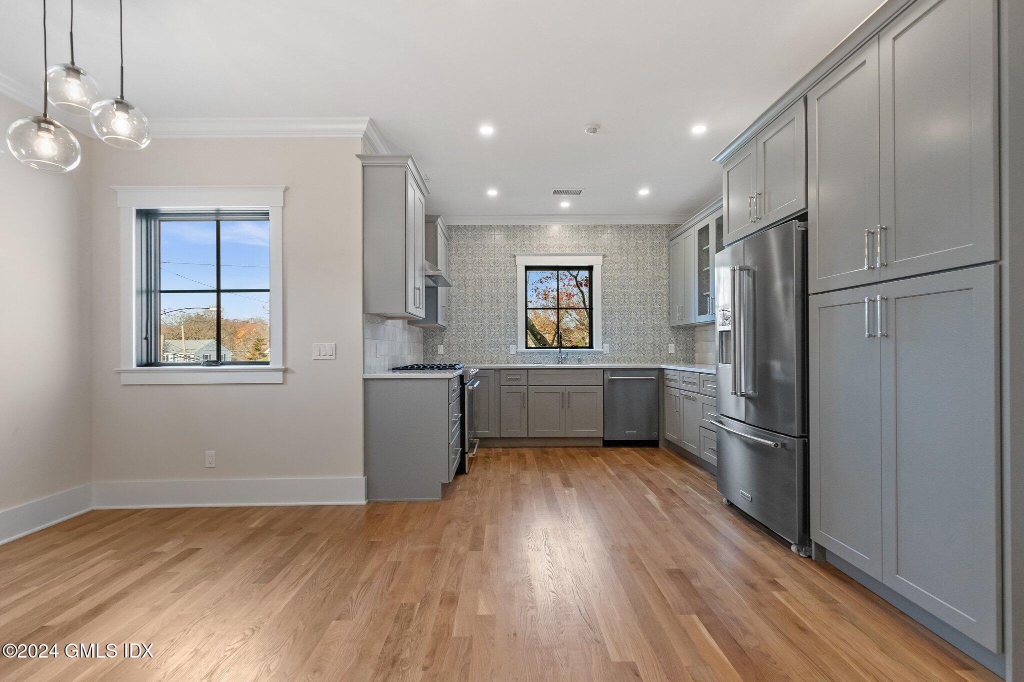 96 Weaver Street, Unit A Greenwich, CT 06831 - Photo 9 of 26 a kitchen with a refrigerator and a sink
