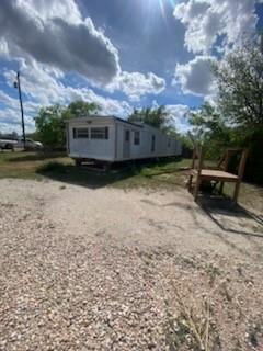 105 Concho Street, Unit A Tye, TX 79563 - Photo 2 of 8 a view of outdoor space with deck and yard
