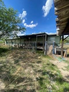 105 Concho Street, Unit A Tye, TX 79563 - Photo 5 of 8 a backyard of a house with table and chairs