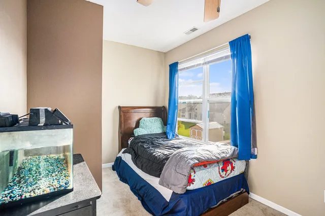 a bedroom with bed and a window