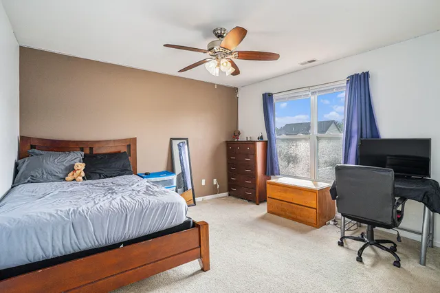 a bedroom with a bed and a chair