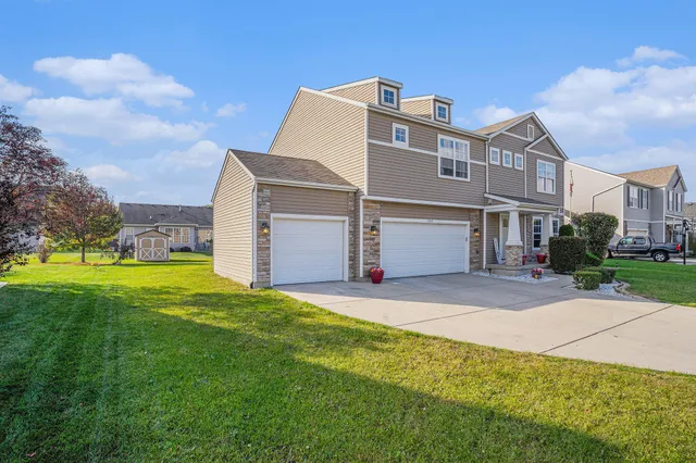 a aerial view of a house with a yard and garage