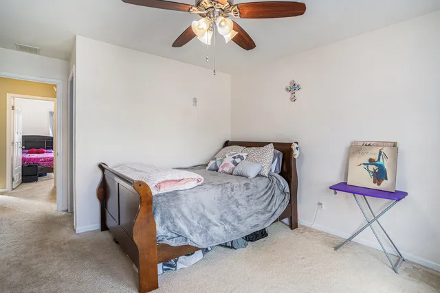 a bedroom with a bed and chandelier
