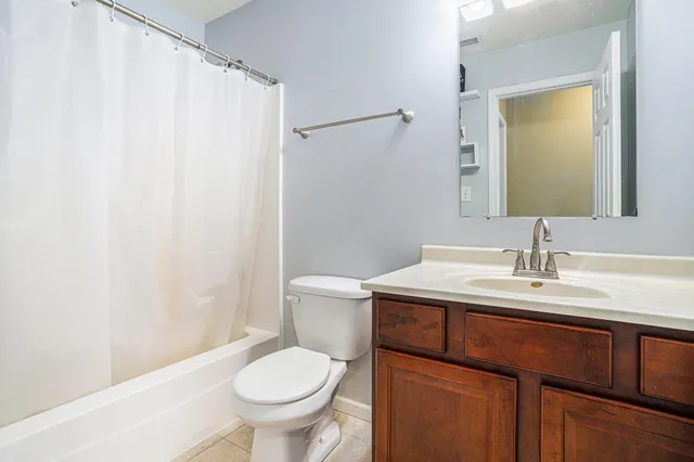 a bathroom with a sink toilet and mirror