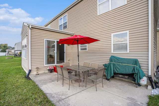 a view of a house with backyard and sitting area