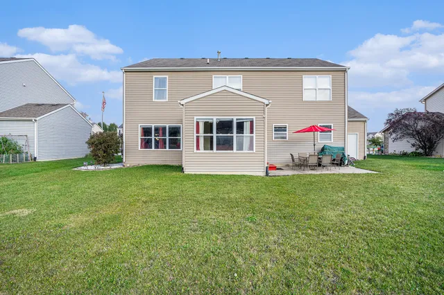 a view of a house with a backyard