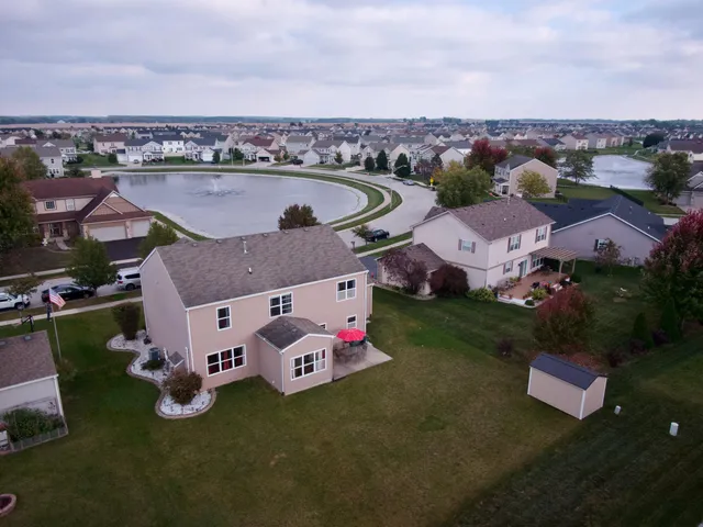 an aerial view of residential houses with outdoor space and swimming pool