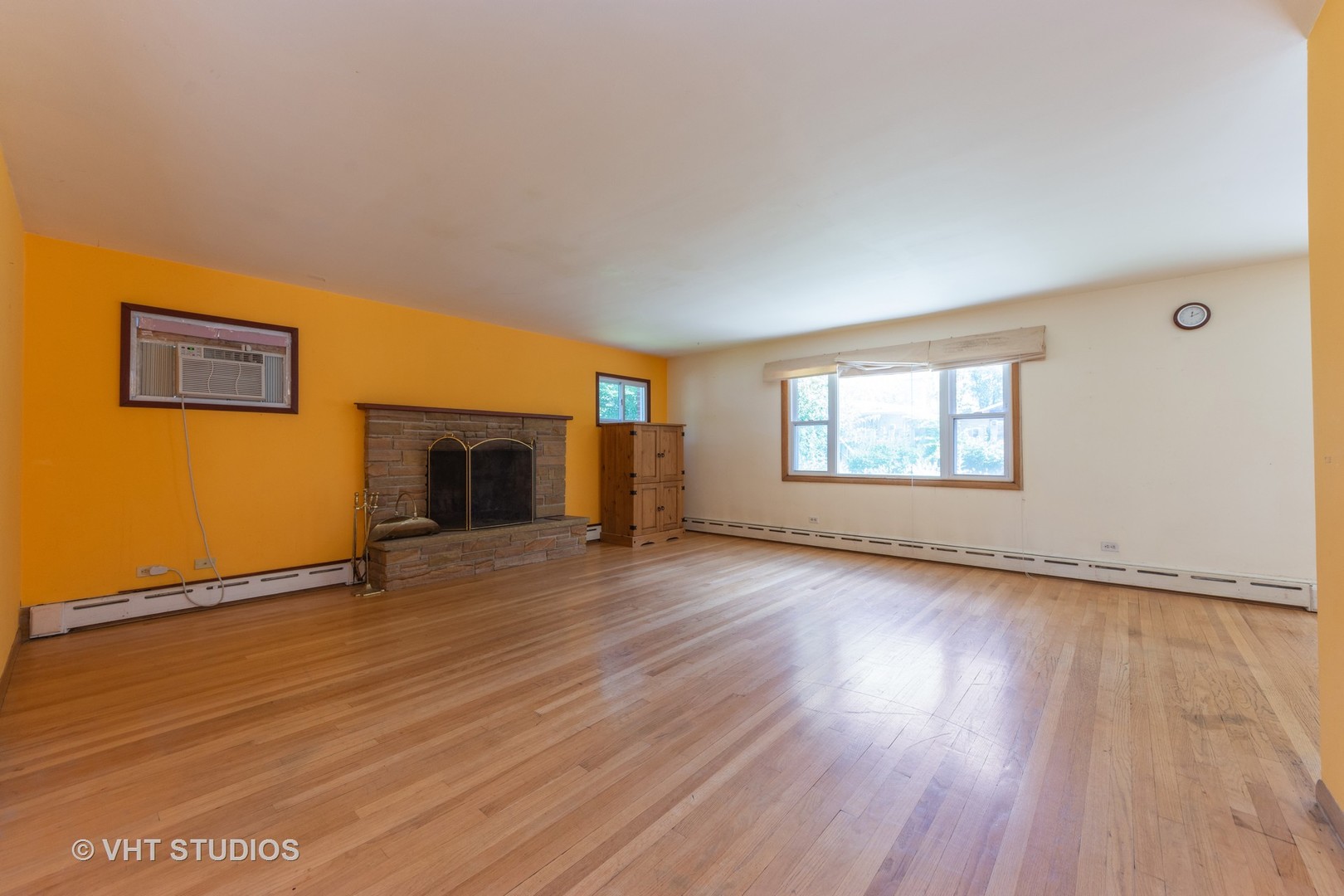 403 North Plum Grove Road Palatine, IL 60067 - Photo 3 of 11 an empty room with wooden floor fireplace and windows