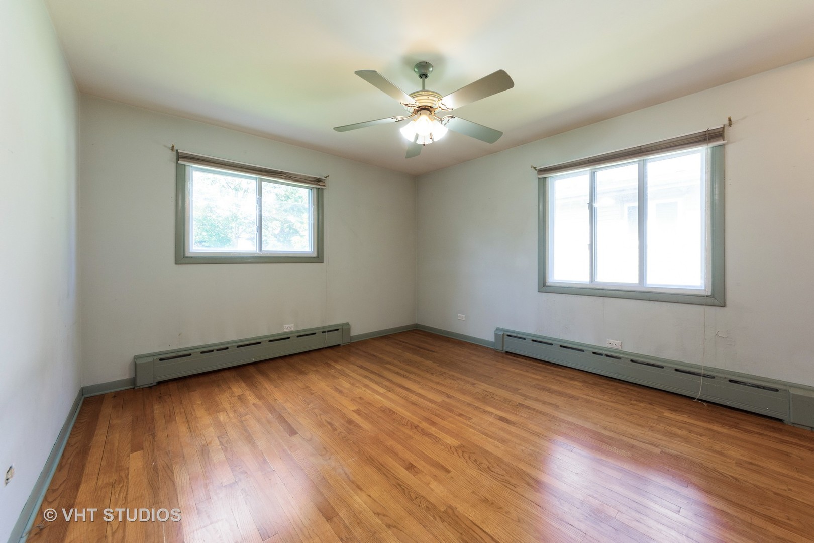 403 North Plum Grove Road Palatine, IL 60067 - Photo 6 of 11 a view of an empty room with wooden floor and a window