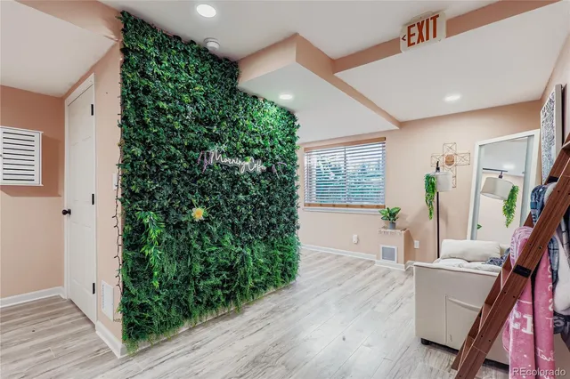 a living room with furniture and a potted plant