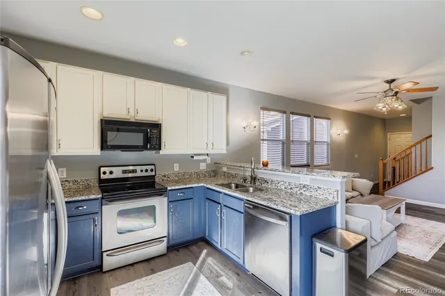 a kitchen with stainless steel appliances granite countertop a stove sink and refrigerator