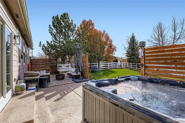 a view of a backyard with sitting area