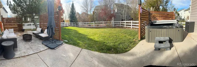 a view of a backyard with sitting area