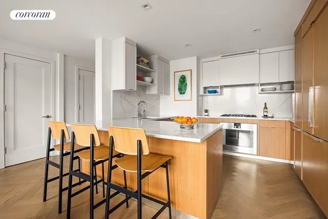 a kitchen with a table chairs sink and cabinets