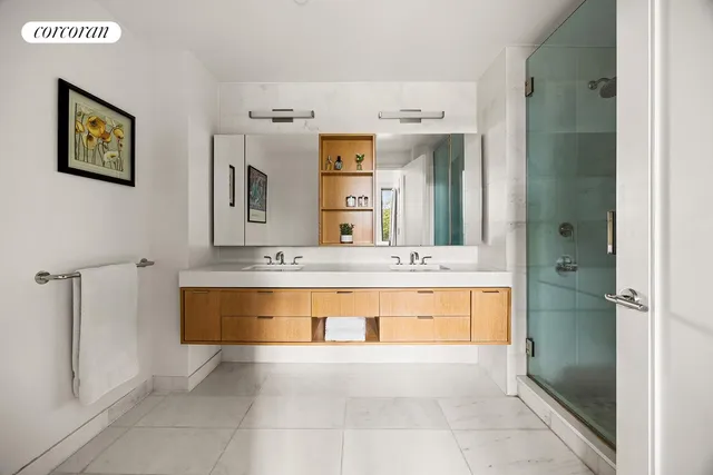 a spacious bathroom with a tub sink and mirror