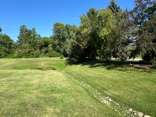 a view of outdoor space with deck and yard