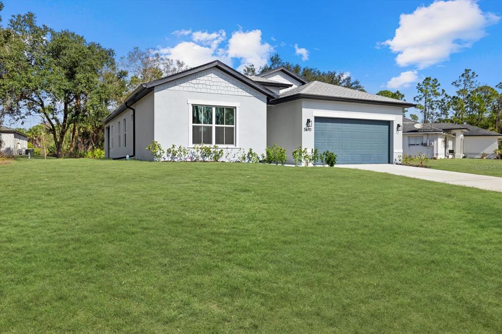 5670 Gilroy Avenue North Port, FL 34288 - Photo 2 of 28 a front view of a house with a garden
