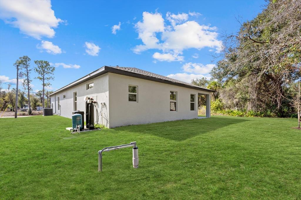 5670 Gilroy Avenue North Port, FL 34288 - Photo 8 of 28 a backyard of a house with table and chairs