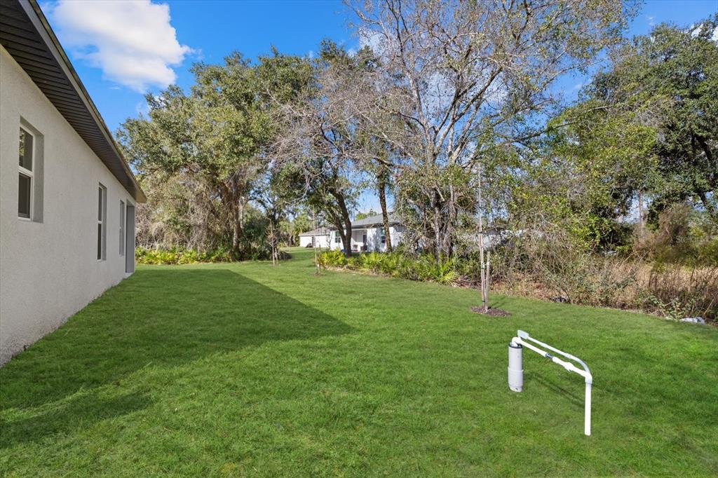 5670 Gilroy Avenue North Port, FL 34288 - Photo 9 of 28 a backyard of a house with lots of green space