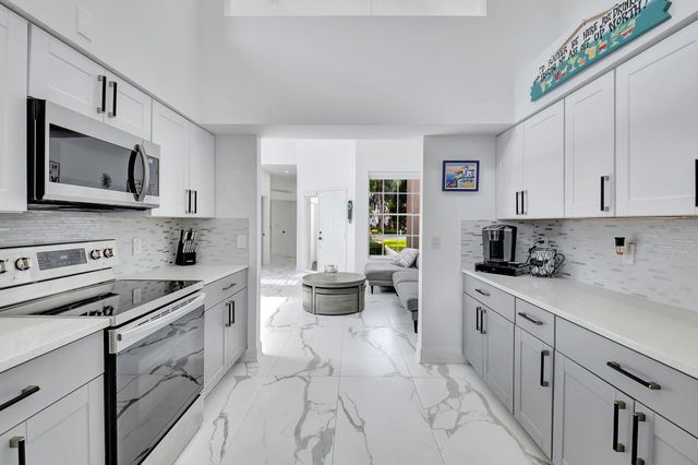 a kitchen with stainless steel appliances a stove microwave and cabinets