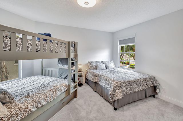 a bedroom with a bed and painting on the wall