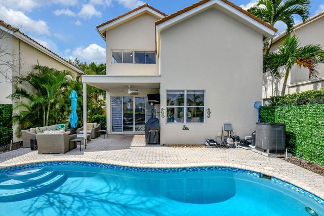 a view of a house with sitting area and garden
