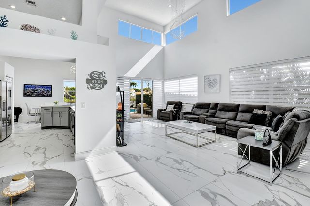 a living room with furniture and large window