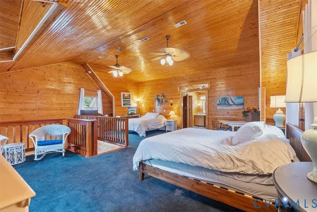 a spacious bedroom with a bed and a chandelier