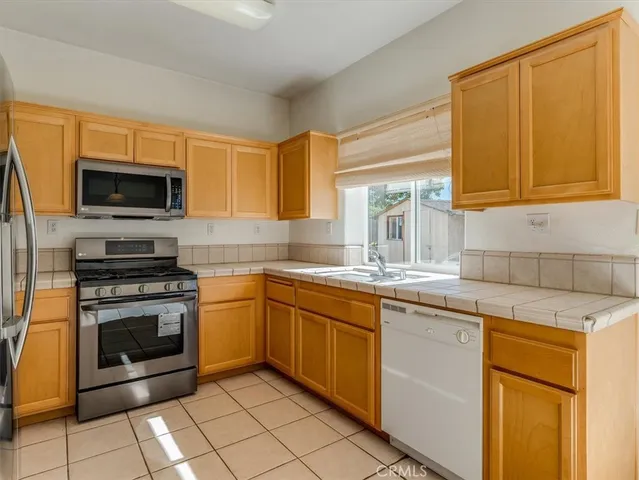 a kitchen with a sink stove and microwave