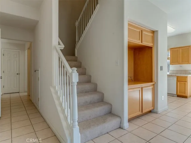 a view of a hallway to an entryway with dining area