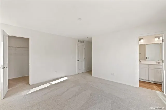 a view of an empty room with a kitchen
