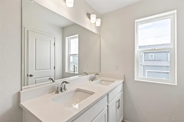 a bathroom with 2 sink and a mirror