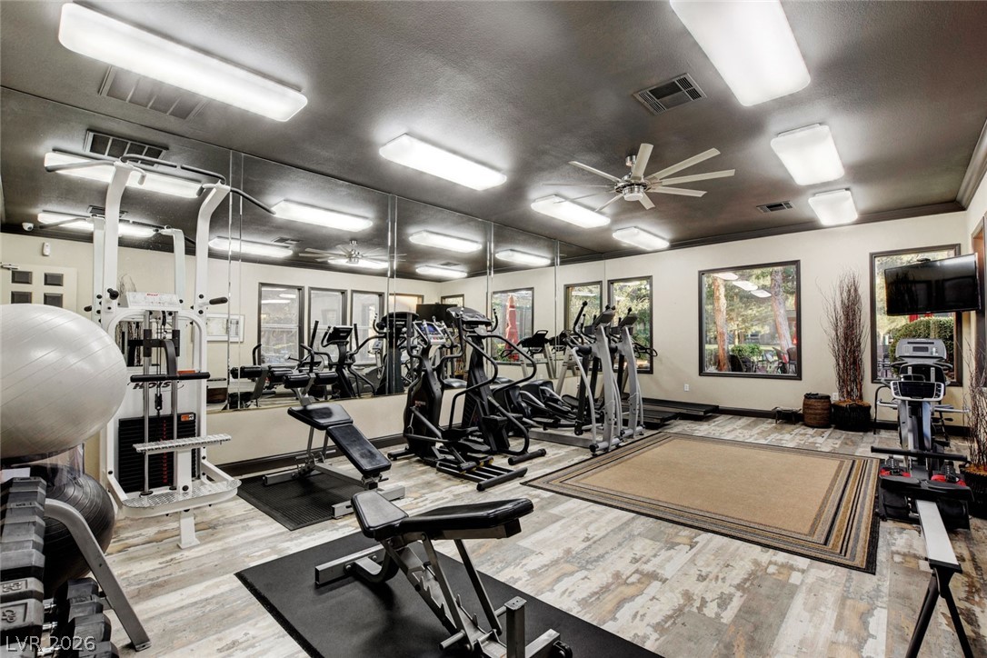 555 East Silverado Ranch Boulevard, Unit 2124 Las Vegas, NV 89183 - Photo 43 of 47 Fitness room offering diverse equipment, mirrored walls, and wide windows for natural illumination.
