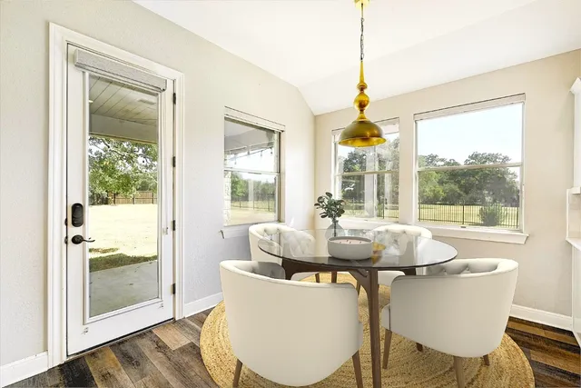 a dining room with furniture and window