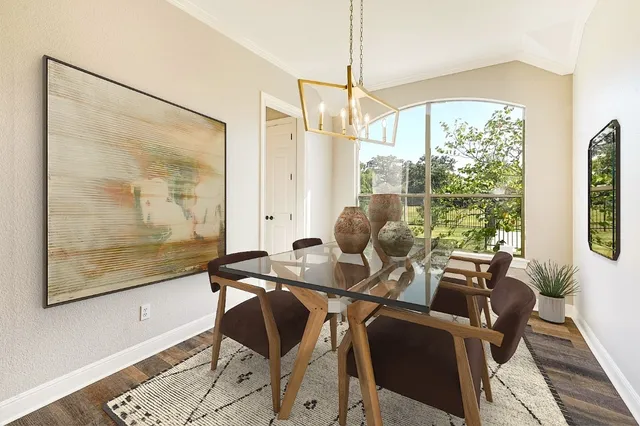 a view of a dining room with furniture wooden floor and a chandelier