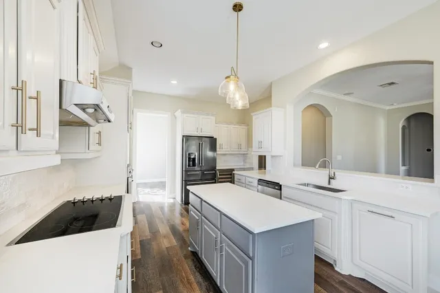 a kitchen with a sink a counter space and stainless steel appliances
