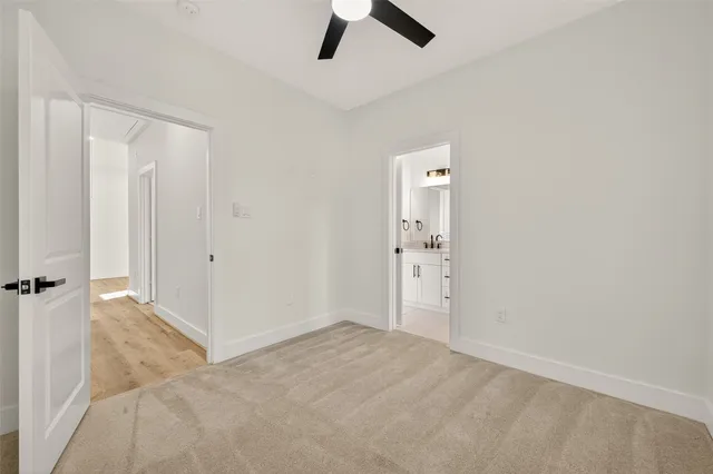 an empty room with closet and a window