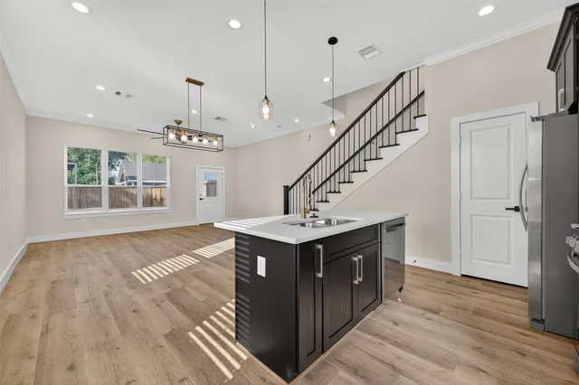 a view of empty room with wooden floor and window