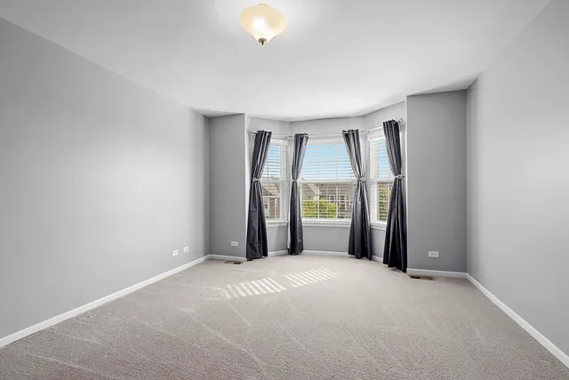 a view of a big room with windows and cabinet