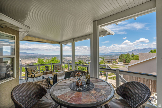 14883 Tooele Lane Draper, UT 84020 - Photo 2 of 49 Covered outdoor patio featuring a multi-tone tile-top table and durable railing system