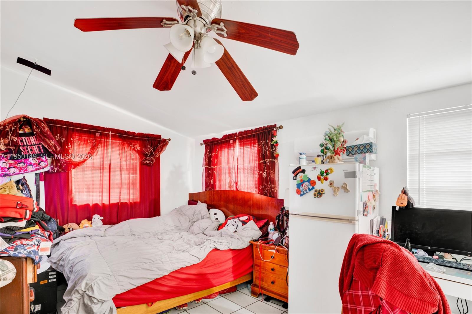 5955 Southwest 4th Street Miami, FL 33144 - Photo 11 of 18 a bedroom with a bed and dresser with wooden floor